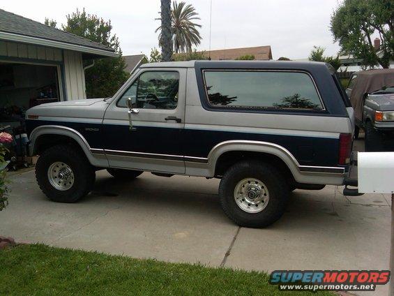 Two-tone gray and dark blue Ford Bronco parked in a driveway