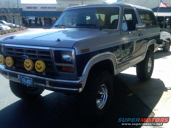 Ford Bronco with smiley face lights on the grille. License plate reads 60Z-USE
