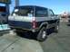 1986 Ford Bronco - This 1986 Ford Bronco is seen from the rear at a gas station, a two-tone paint scheme and off-road tires.
