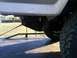 1986 Ford Bronco - Close-up of the rear suspension and tire on a 1986 Ford Bronco.