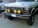 1986 Ford Bronco - This Ford truck features a chrome bumper and grille with four yellow KC lights mounted on the front.