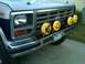 1986 Ford Bronco - This 1986 Ford Bronco features custom KC lights with smiley face covers on the front grille.