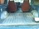 1986 Ford Bronco - Interior view of a blue SUV, focusing on the cargo space and front seats.