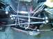 1986 Ford Bronco - Tools are laid out near the suspension components of a vehicle's undercarriage.