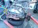 1986 Ford Bronco - An engine, likely removed from a vehicle, is supported by an engine stand and a tire.