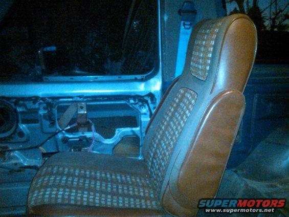 1986 Ford Bronco interior showing driver's seat and door panel removed
