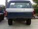 1986 Ford Bronco - This 1986 Ford Bronco features a distinctive two-tone paint job and a prominent '990' decal on its rear window.