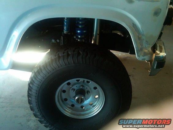 1986 Ford Bronco front wheel and fender with blue suspension components