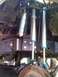 1986 Ford Bronco - Custom suspension components, including multiple shock absorbers with blue accents, are visible in this close-up view.