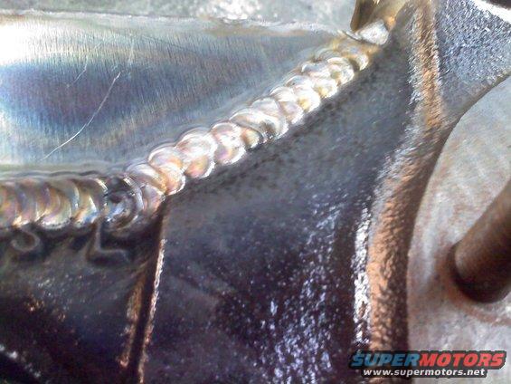 Close-up of a welded metal part with visible weld beads