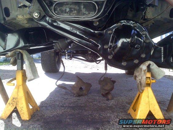 Rear axle assembly on jack stands with brake calipers removed