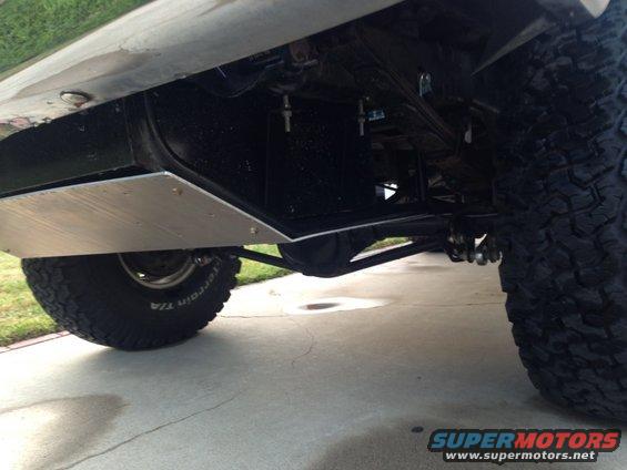 Underside view of a 4x4 with skid plate and large tires