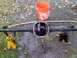 1986 Ford Bronco - Differential housing removed from a vehicle, resting on jack stands outdoors.