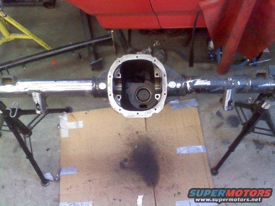 Rear axle assembly on jack stands, with red body panel above