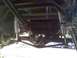 1986 Ford Bronco - The photo shows the undercarriage of a vehicle, focusing on the rear axle and suspension components.