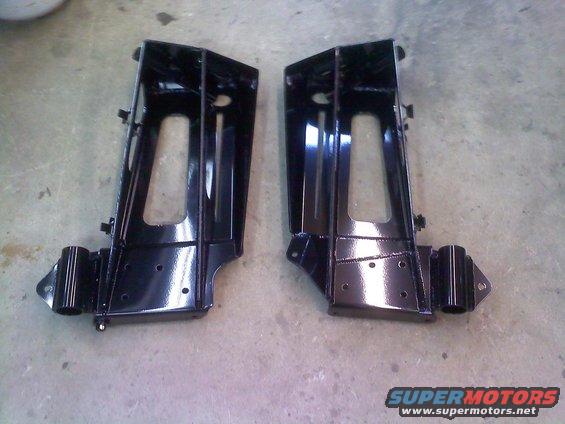Pair of black metal brackets on concrete floor