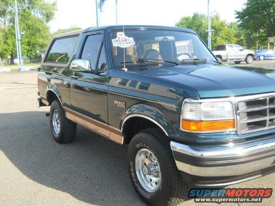 Dark green 1994 Ford Bronco with tan trim, 3/4 front view