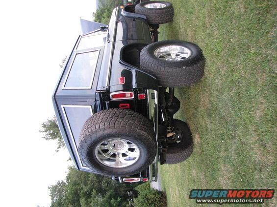 Black 1979 Ford Bronco rear view with large tires and spare tire mounted externally