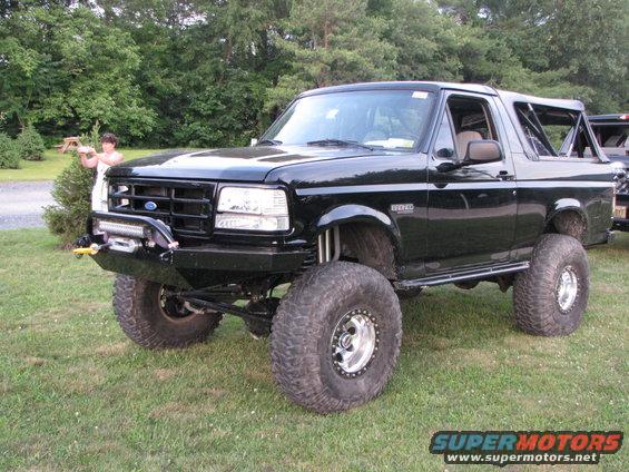 Black lifted Ford Bronco with aftermarket bumper and winch