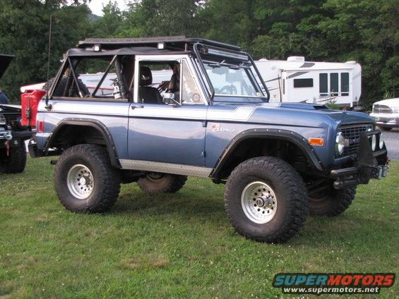 Blue 1979 Ford Bronco with off-road tires and roll cage