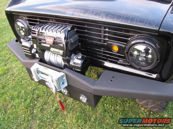 Black Bronco front with winch, aftermarket headlights, and "BLACK EDITION" text on grille