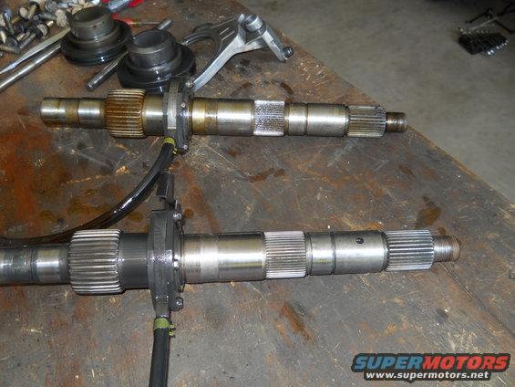 Two transmission input shafts on a workbench