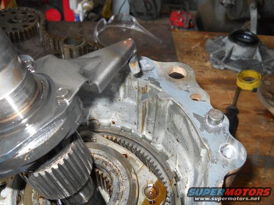 Close-up of a damaged metal transmission component with gears visible
