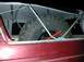 1996 Ford Bronco - A spare tire and jack are stored in the rear of a vehicle, under a canvas cover.