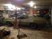 1973 Ford Torino - A 1973 Ford Torino coupe sits in a garage, appearing to be in a state of restoration or repair.