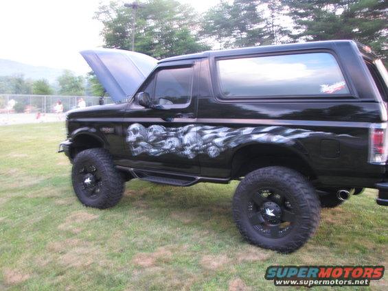 Black SUV with skull graphics and checkered flag airbrushing, hood up