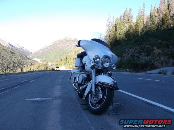 White motorcycle parked on mountain road