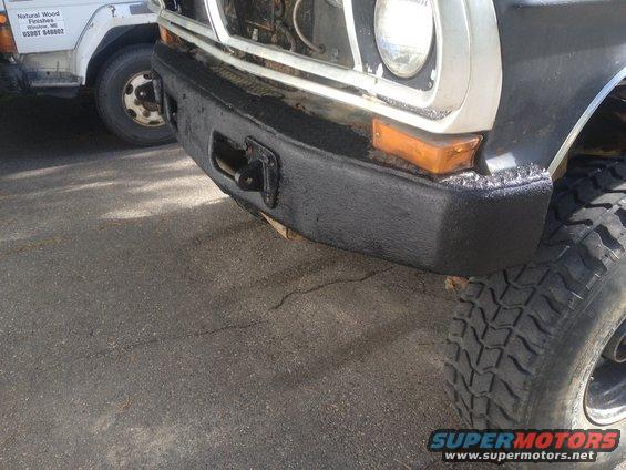 Front bumper and tire of a 1970 Ford F-250 with a tow hitch