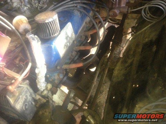 Engine bay shot showing blue valve covers, air filter, and wiring