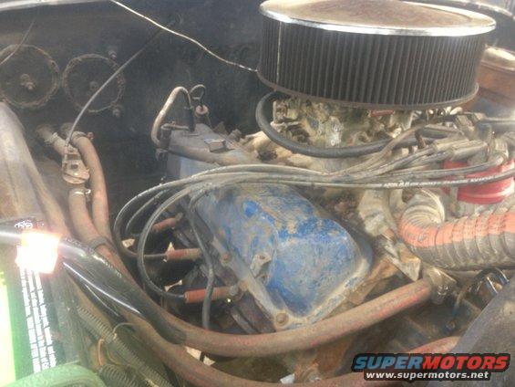 1970 Ford F-250 engine bay with blue valve covers, air filter, and carburetor