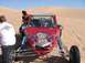 1993 Ford Taurus - A red dune buggy with flame graphics is parked in the sand dunes on a sunny day.