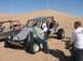 1993 Ford Taurus - People pose with dune buggies in a desert landscape under a clear blue sky.