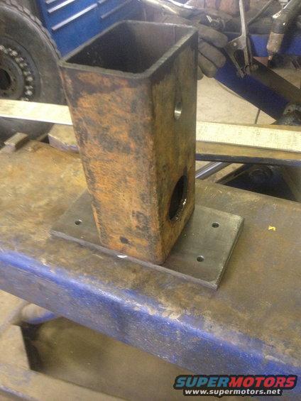 fabricated metal bracket welded to a base plate