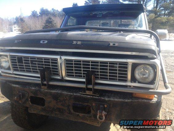 Front view of a 1970 Ford F-250 with a custom brush guard and roof-mounted light bar