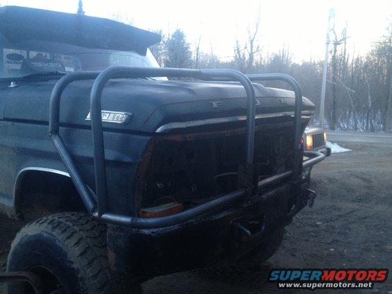 Front end of a 1970 Ford F-250 with a large metal brush guard and off-road tires