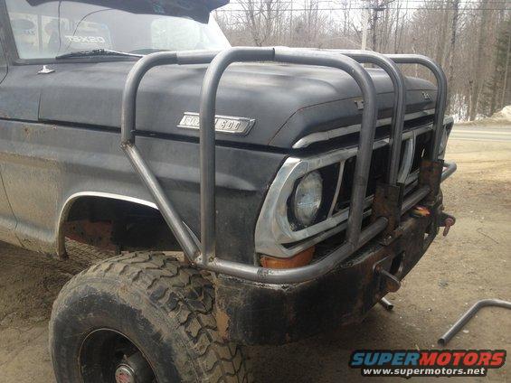 Black 1970 Ford F-250 front view with custom brush guard and large tires
