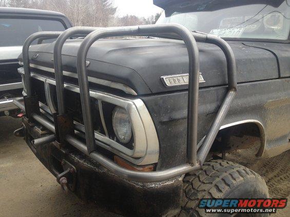 1970 Ford F-250 front end with custom brush guard and another truck to the left