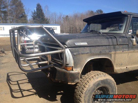 1970 Ford F-250 with custom brush guard and off-road tires parked outdoors