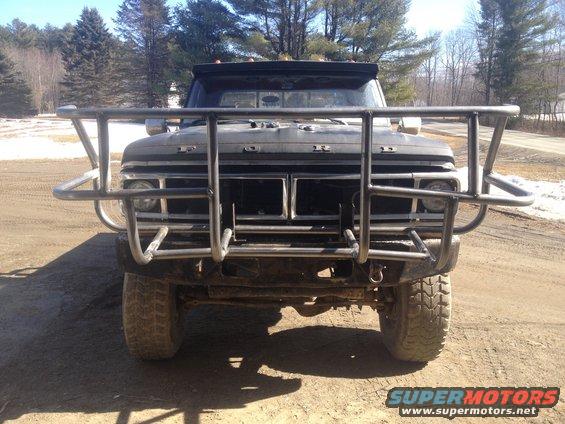 Black 1970 Ford F-250 with a large metal brush guard, front view