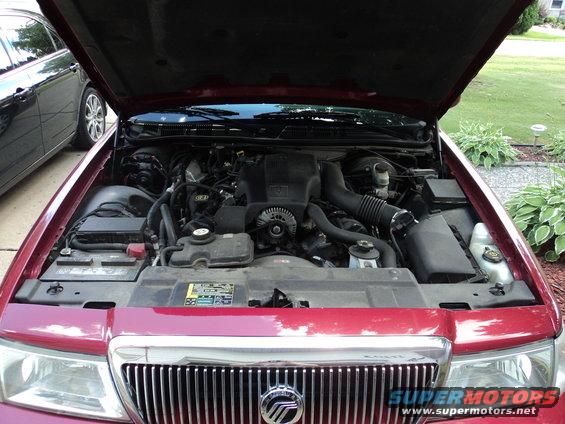 Red 2004 Mercury Grand Marquis engine bay with hood open