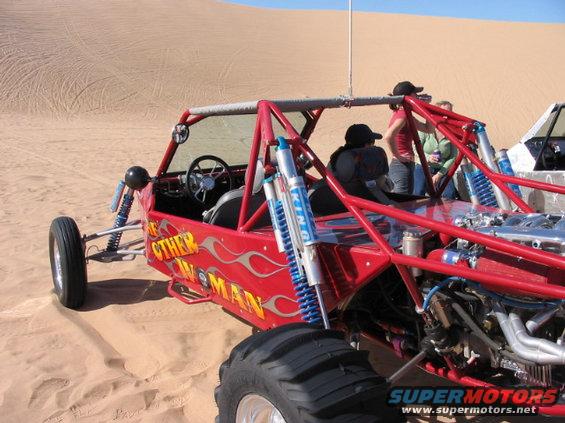 Red dune buggy with flames and text 'The Other Woman' on its side