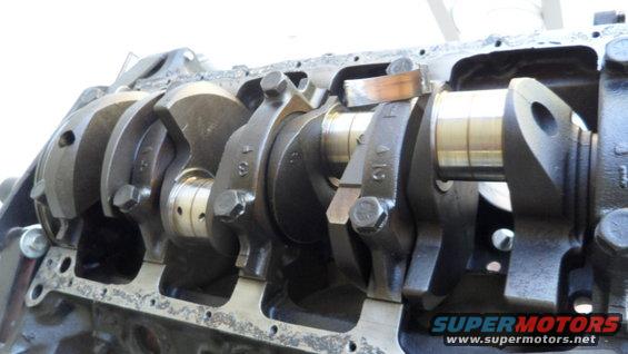 Engine crankshaft with connecting rods attached, showing bearing surfaces