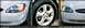 2000 Ford Taurus - Close-up of a white 2001 Ford Taurus, its headlight and wheel.