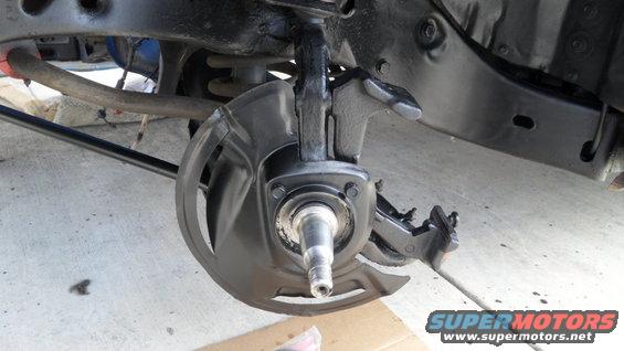 Front suspension component with brake dust shield