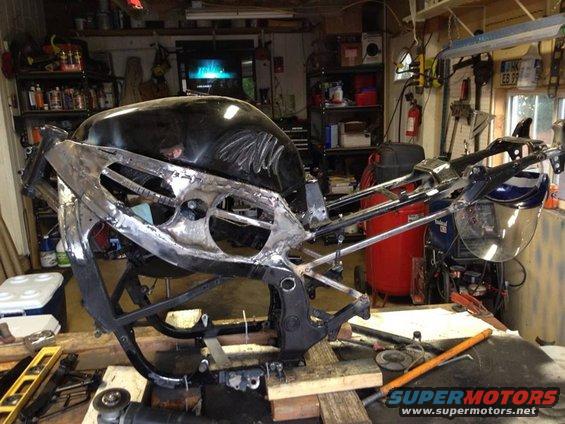 tankon.jpg With the tank on for the final fit. I cut the rear as well and ran all tubes so they flow the same lines forming a double V or chevrons, if you will, for the lower portion of the frame.