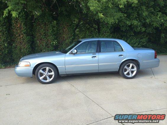 2003 Mercury Grand Marquis, side view, light blue paint, alloy wheels